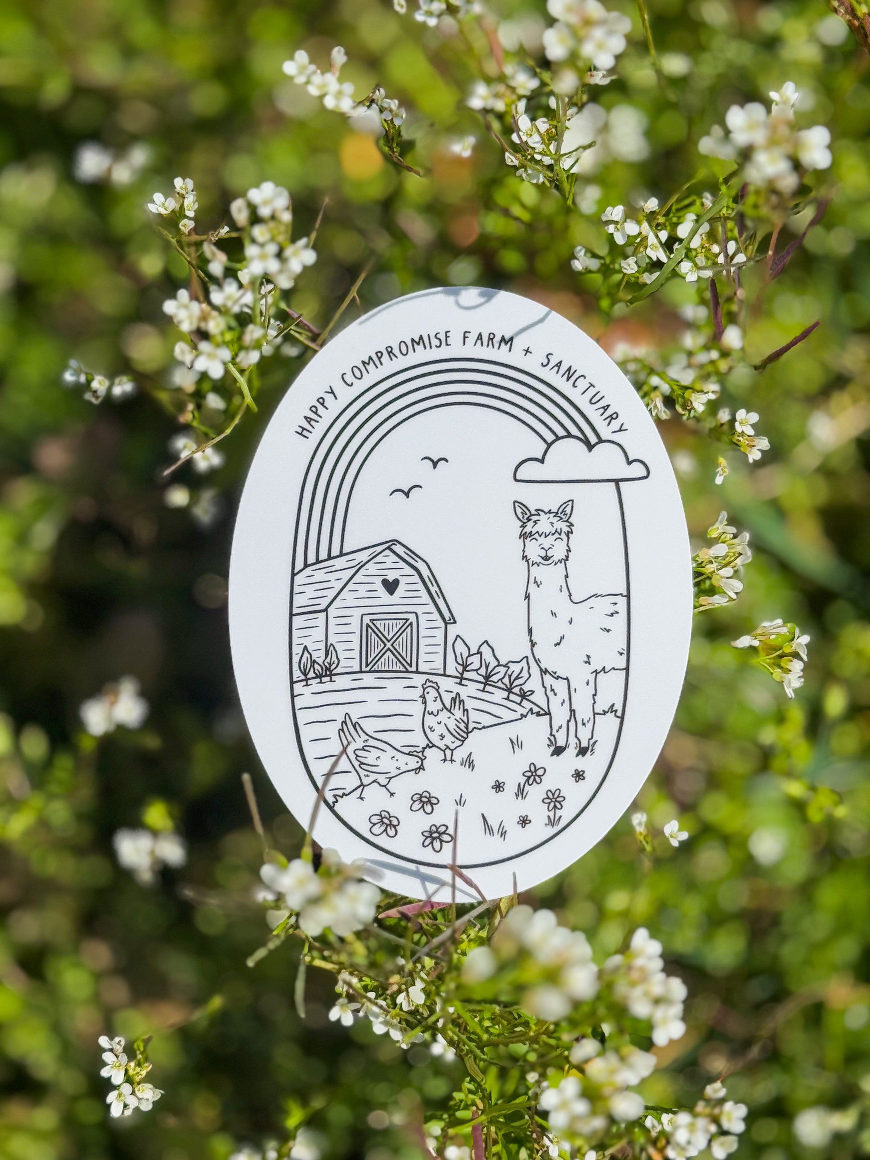 Black and white oval sticker with an illustration of a farm scene with an alpaca, chickens, a barn, and a rainbow, surrounded by blooming white flowers.