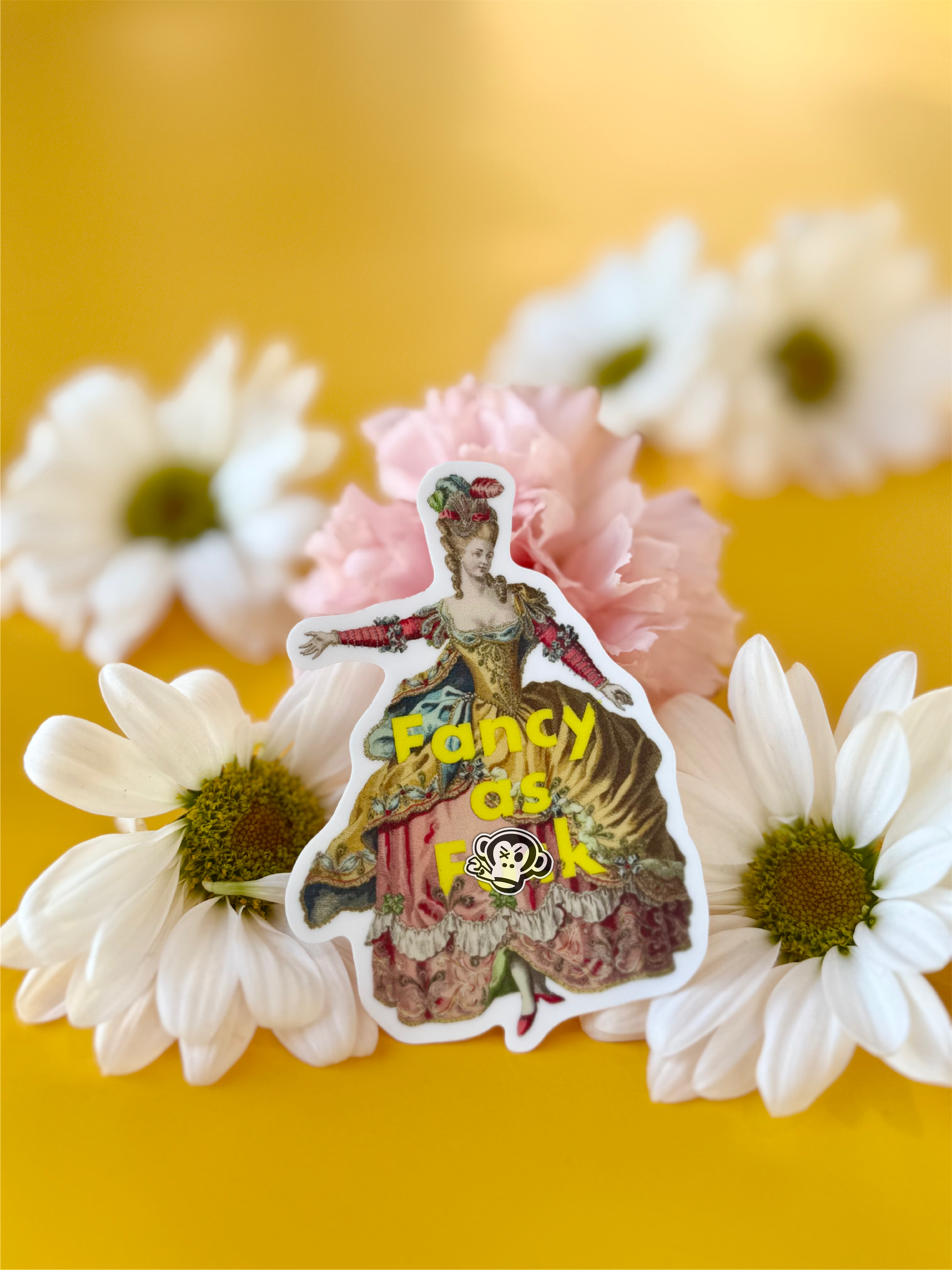 A whimsical die cut sticker of an 18th century woman in a dress, with words saying "Fancy as Fuck", gracefully perched on vibrant flowers.