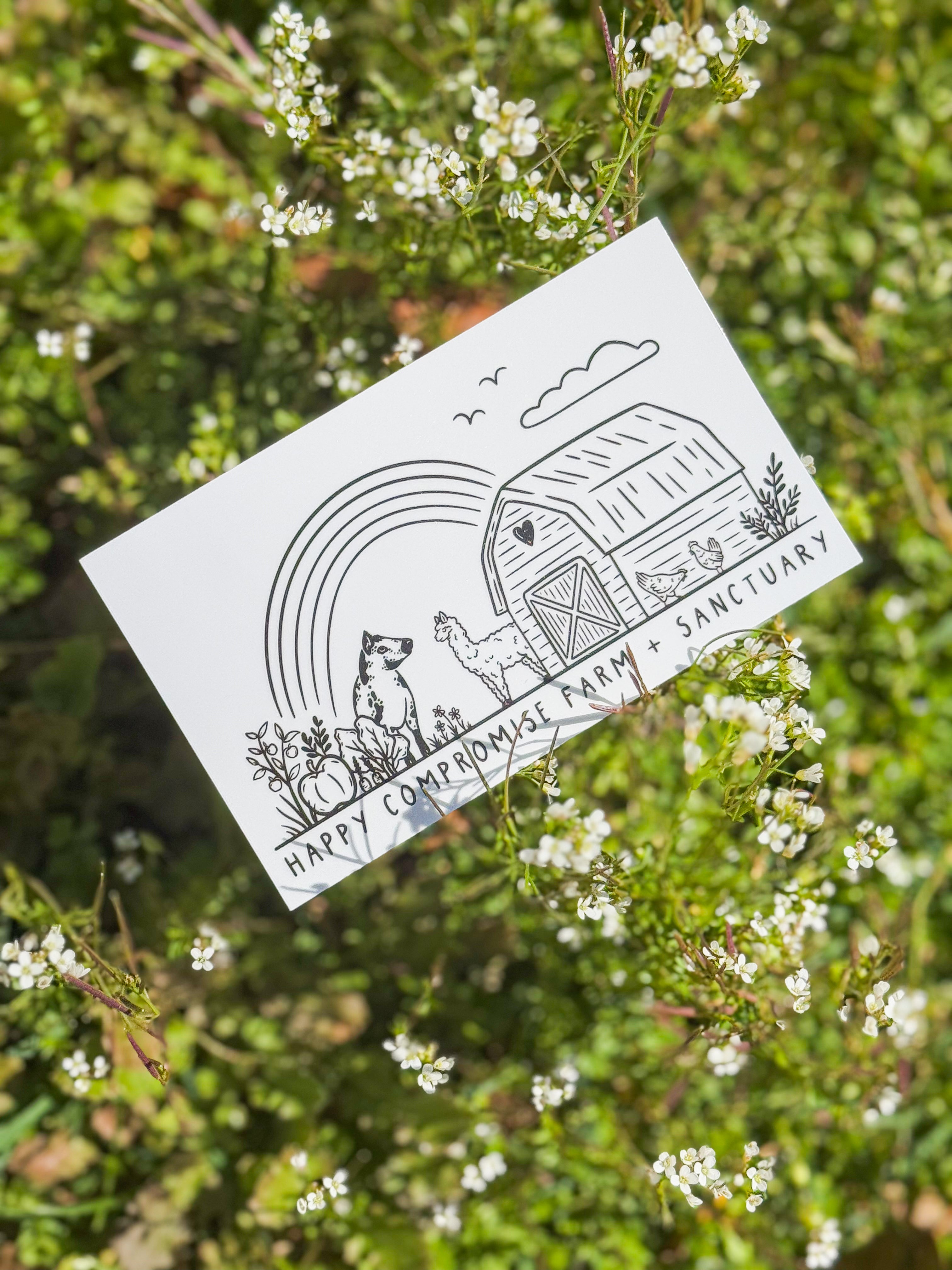 A rectangle sticker featuring a simple line drawing of a barn, a rainbow, and animals like chickens and a goat, titled "Happy Compromise Farm + Sanctuary," set against lush greenery and small white wildflowers. The mood is peaceful and idyllic.